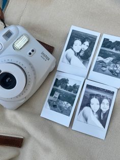 a camera and four polaroid pictures sitting on a bed next to a bag with the same photo