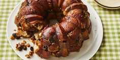 a bundt cake sitting on top of a white plate next to a green and white checkered table cloth