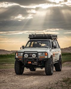 an off road vehicle parked on a dirt road