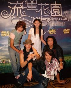 a group of people posing in front of a sign