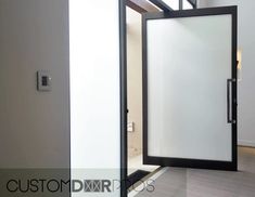 an open door in the middle of a room with white walls and wood flooring