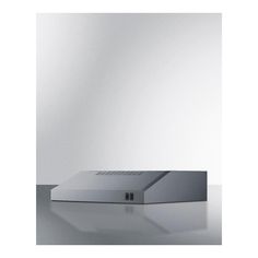 the back side of a laptop computer on a table with a white wall in the background