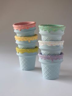 four ice cream cones are stacked on top of each other in different colors and designs