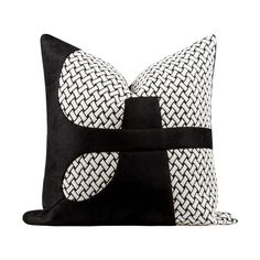 a black and white pillow with an abstract design