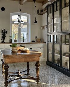 a kitchen with an old fashioned table in the center