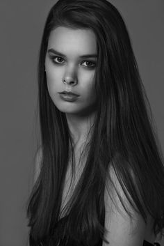 a woman with long hair posing for the camera