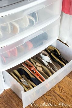 an open drawer with several pairs of shoes in it and the bottom drawer is empty