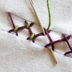 two crocheted stitches are next to each other on a white piece of cloth