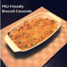 a casserole dish with broccoli in it on a checkered table cloth