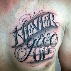 a man's chest with the words never give up tattooed on his left side