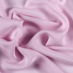 a close up view of a pink fabric with very soft folds on the top and bottom