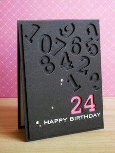 a birthday card with the number twenty four on it and numbers cut out of black paper