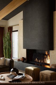 a living room filled with furniture and a fire place next to a window covered in curtains