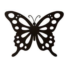 a black metal butterfly with white dots on it's wings, flying in the air