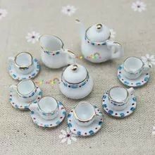 miniature tea set with matching saucers and cups on a tableclothed cloth background