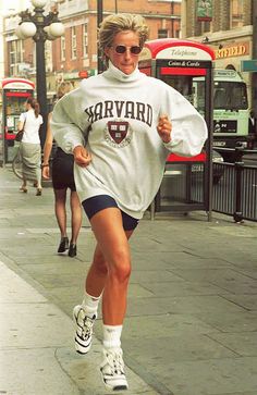 a woman running down the street in shorts