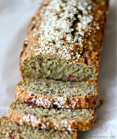 a loaf of bread with cranberries and powdered sugar on top