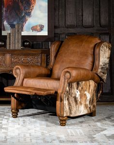 a brown leather recliner chair sitting in front of a painting on a wall with an animal print