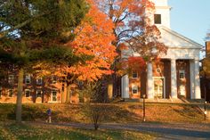 a church with a clock tower in the fall