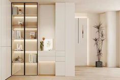 a living room filled with lots of white furniture and tall bookshelves next to a potted plant