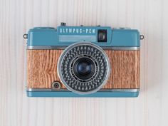 an old fashioned camera mounted on a wooden wall