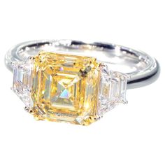 a fancy yellow diamond ring with three baguets