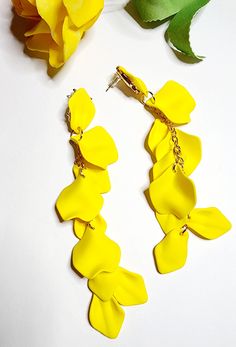 Treat yourself or surprise someone special with these exquisite earrings that are as beautiful as they are versatile. Don't miss out on the opportunity to express your individuality and embrace your inner fashionista, get yours today and let your style blossom! Trendy Adjustable Drop Clip-on Earrings, Chic Flower-shaped Matching Earrings, Chic Flower-shaped Matching Earrings Jewelry, Elegant Yellow Dangle Flower Earrings, Chic Flower-shaped Jewelry With Matching Earrings, Chic Flower Shaped Jewelry With Matching Earrings, Spring Party Dangle Jewelry, Spring Party Drop Earrings, Drop Earrings For Spring Party