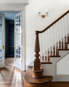 an entry way with stairs and glass doors