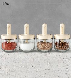 four glass jars with lids filled with spices