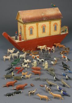 an assortment of toy animals including horses and dogs in front of a boat with a house on top