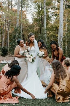 bride surrounded by her bridesmaids who are adjusting her wedding dress while they are wearing rose gold and yellow gold satin and silk bridesmaid dresses Complete Wedding Planning Checklist, Rose Gold Bridesmaid Dress, Outdoor Celebration, Rose Gold Bridesmaid, Bridesmaids Dress Inspiration, Gold Bridesmaid Dresses, Mismatched Bridesmaids, Perfect Bridesmaid Dress, Gold Bridesmaids