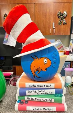 there is a cat in the hat on top of books