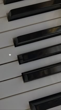 the piano keys are black and white with hearts painted on each one's sides