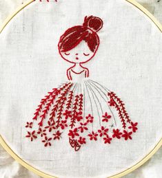 a red and white embroidery pattern with a girl in a dress