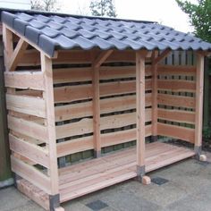 a small wooden shelter with metal roof