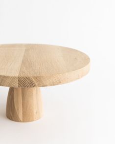 a round wooden table on a white background