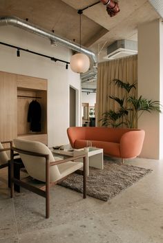 a living room filled with furniture next to a tall ceiling fan and window covered in curtains