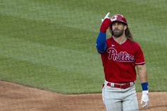 a baseball player holding his hand up in the air