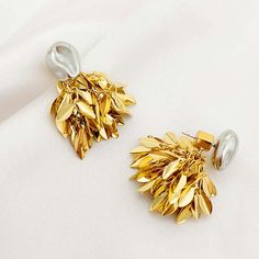 ✦ Discover the sophistication and versatility of our Gold Silver Tones Double Wear Leaf Fringe Earrings Set! These elegant earrings feature a silver pendant that can be worn as a stud or paired with a gold tassel for a stunning 2-piece set. The single abstract stud exudes cool minimalism, while the gold leaf sequin fringe adds a pop of artistic flair. Get ready to rock any look with these exclusive earrings. ----------- DETAILS----------- *Sold in Pair - Color: Gold - Size(Length* Width): 3.8cm Silver Dangle Clip-on Earrings Gold Plated, Gold Metal Drop Bridal Earrings, Gold Teardrop Cluster Earrings For Anniversary, Silver Plated Earrings As Gift, Silver Plated Earrings For Gift, Gold Pendant Metal Earrings, Gold Metal Pendant Earrings, Silver Plated Metal Earrings, Silver Gold-plated Tarnish-resistant Clip-on Earrings