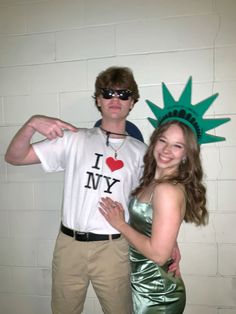 a man and woman dressed up as the statue of liberty