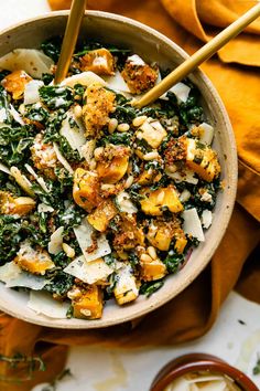 a bowl filled with spinach, cauliflower and cheese