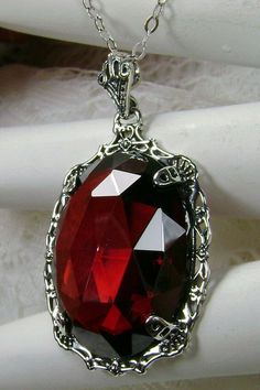 "Red Garnet Cubic Zirconia Pendant Bubble Design#P10 Custom Made Inspired by Victorian era designs, I now offer this lovely Antique reproduction in sterling silver. The flawless 22ct faceted Red Garnet Cubic Zirconia (CZ) is 24mm long (15/16th\") and 18mm in width (3/4th\"). The entire pendant is 1 1/2th inches long and 7/8\" wide. The chain (if chosen) is between 18-20 inches in length and is marked 925 as well. Notice the beautiful craftsmanship of the Victorian filigree setting. This pendant Red Gothic Necklace For Formal Occasions, Exquisite Red Jewelry For Gift, Red Jeweled Jewelry For Evening, Exquisite Red Oval Necklace, Exquisite Red Oval Necklaces, Formal Red Garnet Jewelry, Antique Jeweled Red Jewelry, Elegant Red Jeweled Necklace, Red Evening Jewelry