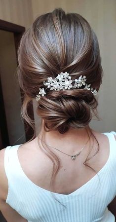 a woman wearing a hair comb with flowers in it