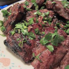 a plate with meat and greens on it