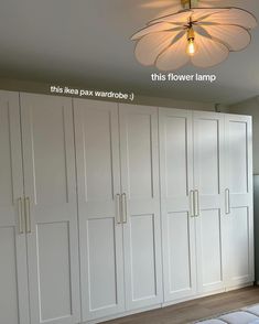 a bedroom with white closets and lights above them