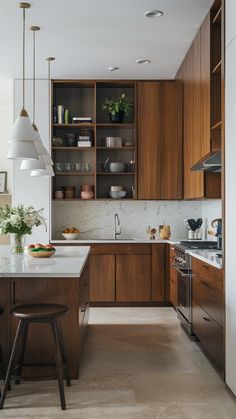 a kitchen with wooden cabinets and white counter tops, along with an island in the middle