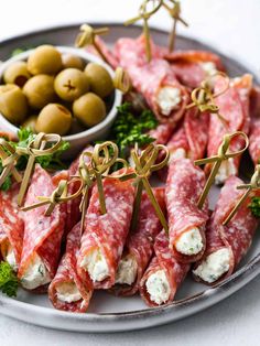 several appetizers are arranged on a plate with olives