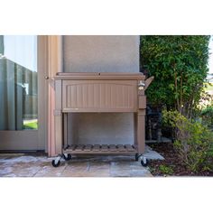 a small wooden cart sitting outside of a house