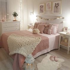 there is a bed with pink and white blankets on it