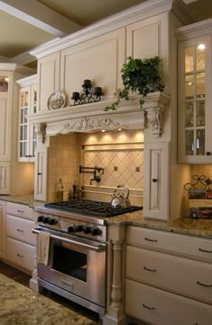 a kitchen with an oven, stove and cabinets in it's center island area